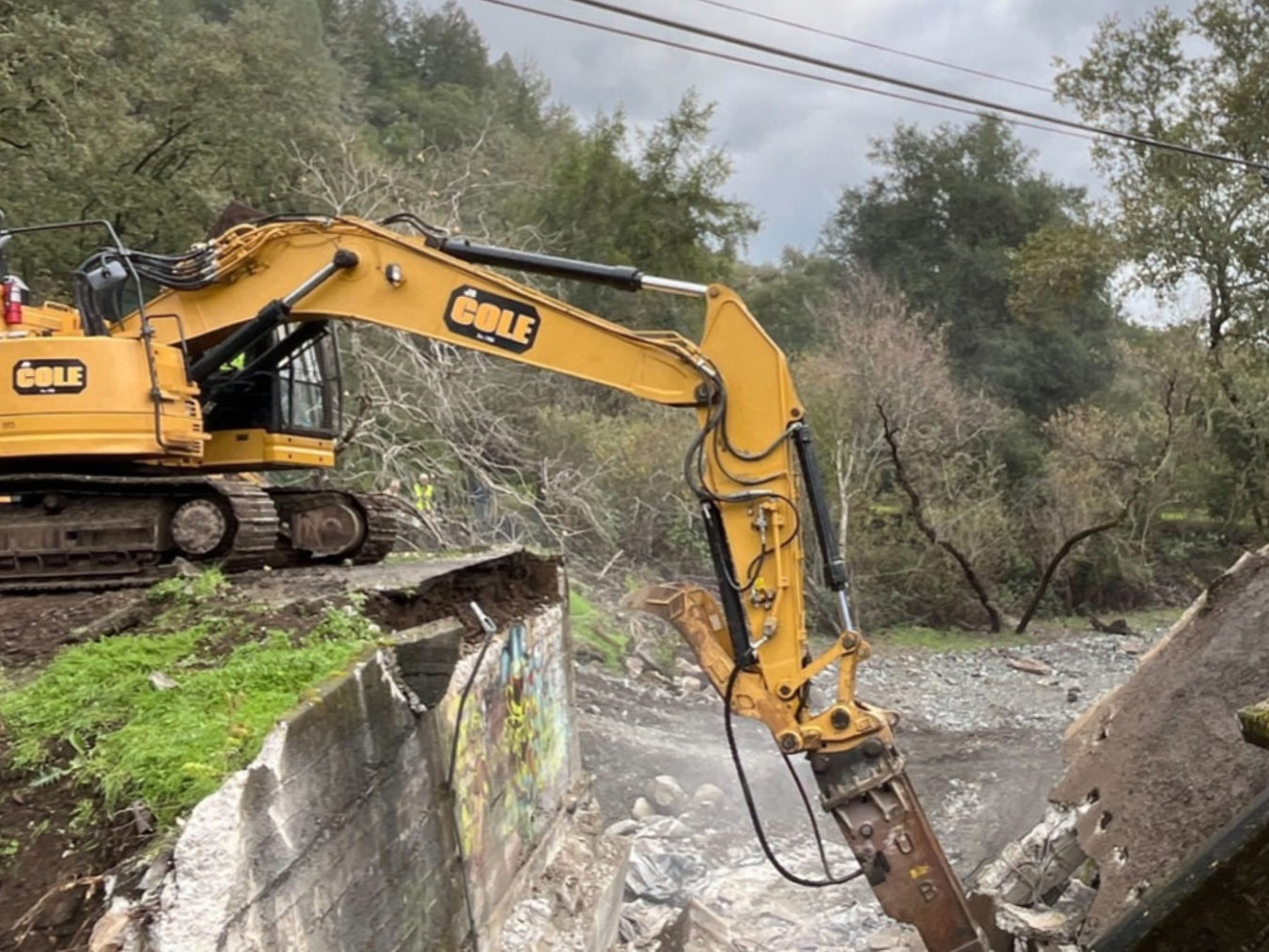 A crane removes the old bridge over Sulphur Creek during restoration